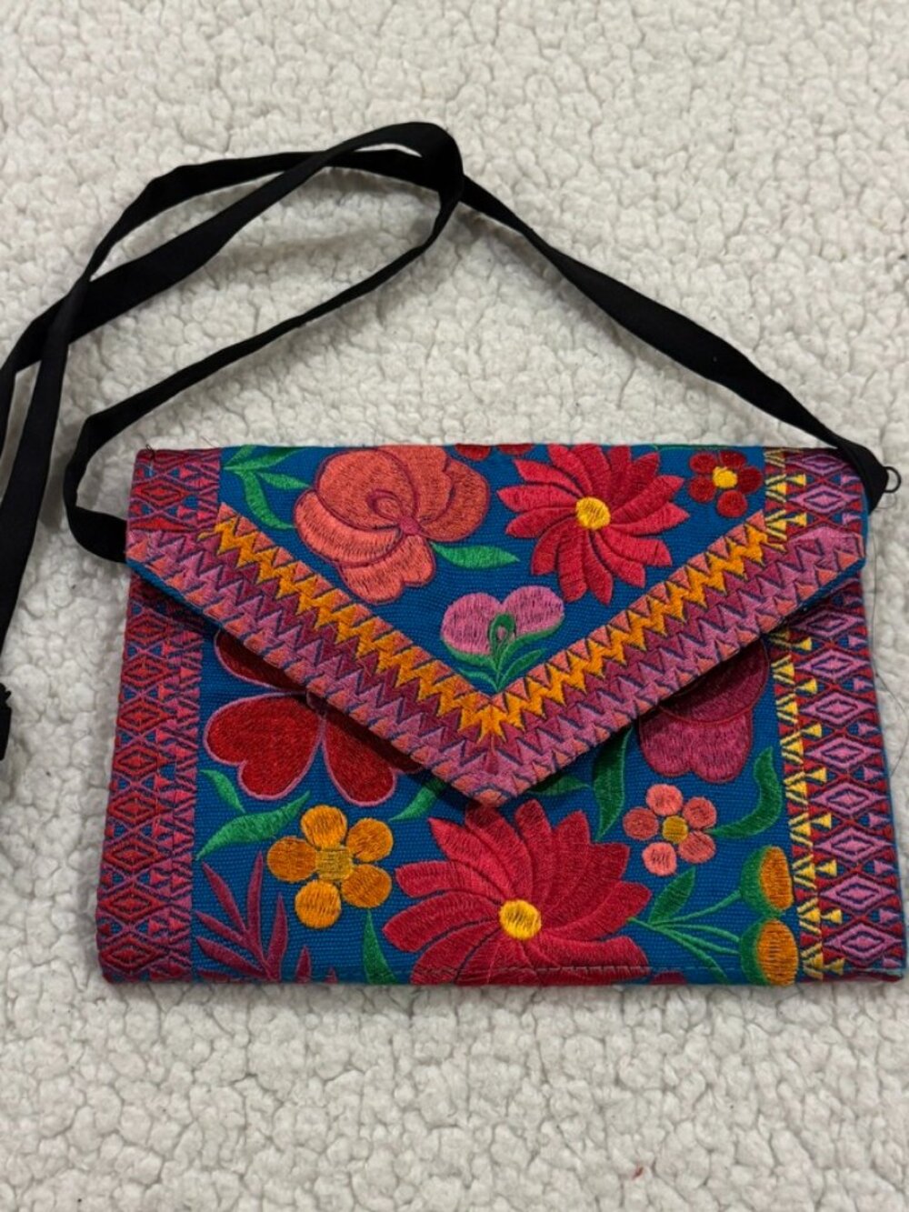 Small embroidered purse with floral pattern design.